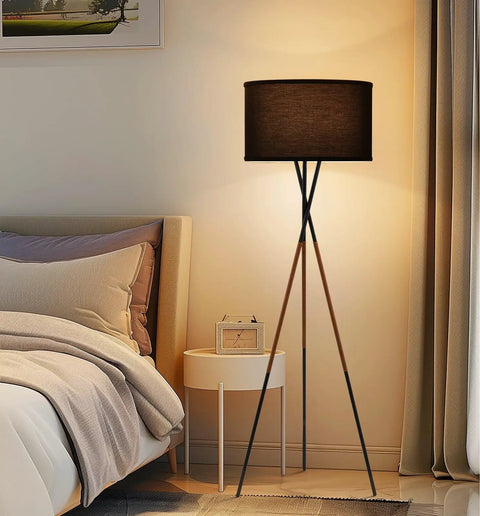 60 Inch Tripod Floor Lamp In Brushed Nickel With Gray Linen Drum Shade in cozy bedroom setting
