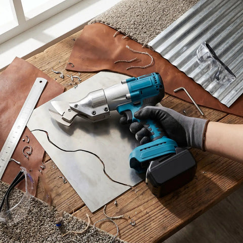 Aolidsive Cordless Metal Shear Delivering 400Nm Torque For Bl1830 Battery cutting metal sheet on a wooden table with leather and tools.