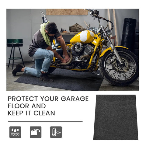 Man working on motorcycle using Garage Floor Mat For Oil Spills 29 By 36 Inches Reusable And Washable Oil Absorbent Pad