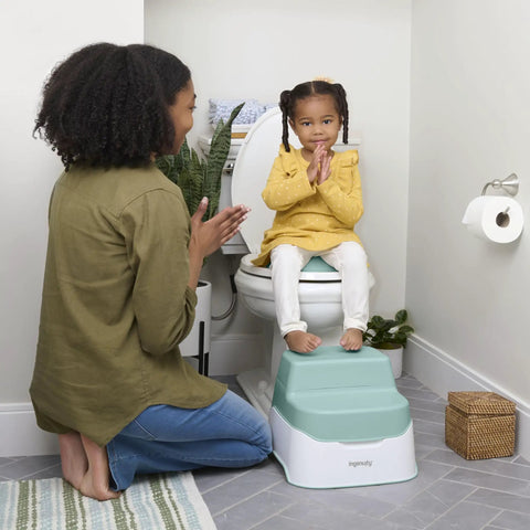 Fast Track Potty Training With This Game Changing 3 In 1 Potty Seat That Transitions From Floor Chair To Toilet Topper And Rugged Step Ladder Featuring A Quick Pour Removable Pot For Toddlers Eighteen Months Plus in use with child, showing grab bars and step ladder.
