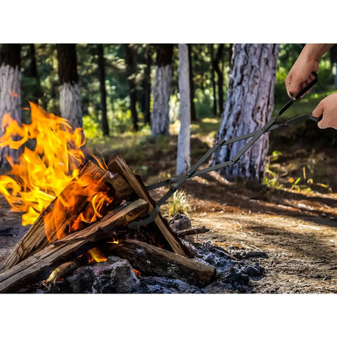 Using Built Tough Campfire Tongs With Smart Scissor Grip And Powder Coated Steel Frame to manage a fire's logs safely.