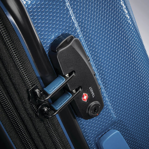 Luggage: blue hard-shell suitcase with built-in TSA lock and blue zipper pulls (close-up)