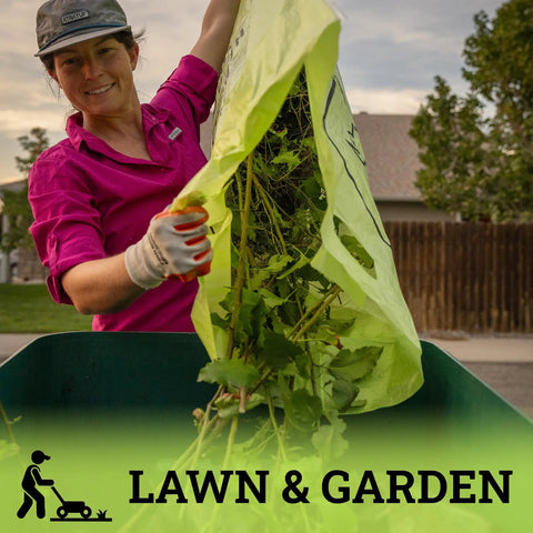 Woman using Ultimate Heavy Hitter Contractor Bags Built Like A Tank For Renovation Debris And Yard Waste 42 Gallon Tear Resistant Polypropylene Reusable Jobsite Trash Bags 10 Pack for yard clean-up.