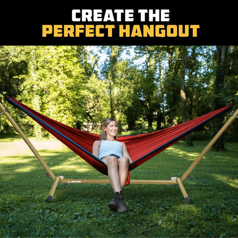 Portable Hammock Stand Hang Anywhere 106 By 42 Inches With 440 Pound Capacity in use outdoors, person relaxing on hammock.