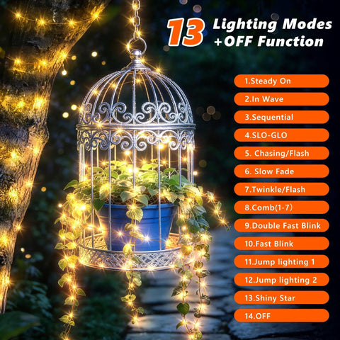 Rechargeable 33Ft 100LED Copper Wire String Lights With Timer And 13 Modes illuminating a birdcage with plants at night
