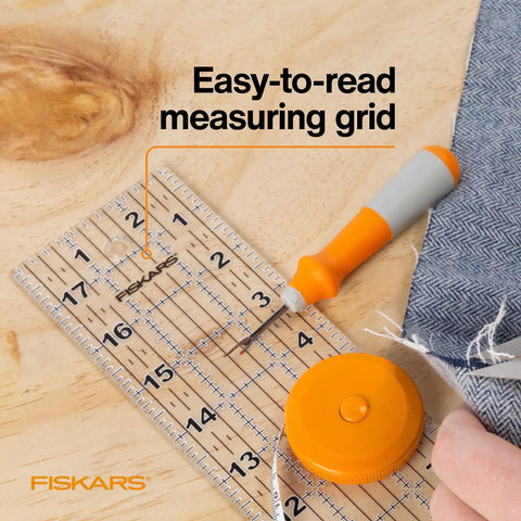 Seam Ready Sewing Ruler 3 By 18 Inch Acrylic Grid Ruler with highlighted seam allowances for fabric cutting on table.