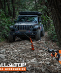 SUV using Heavy Duty Synthetic Winch Rope Kit Half Inch By Ninety Two Feet With Forged Hook Isolator Rubber Stopper in rugged forest.