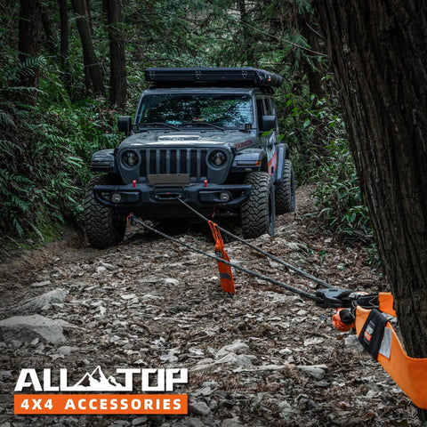 SUV using Heavy Duty Synthetic Winch Rope Kit Half Inch By Ninety Two Feet With Forged Hook Isolator Rubber Stopper in rugged forest.