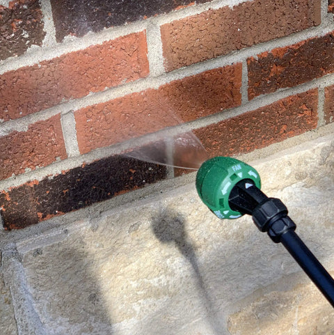Applying The Real Deal Deep Penetrating Siloxane Masonry Sealer For Brick Concrete And Stucco using a spray nozzle on bricks.