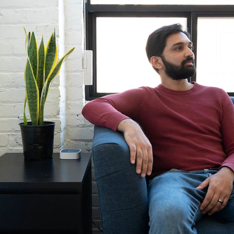 Man sitting by window with Smart Bridge For Window Shades 2025 Edition Connects With Alexa, Google Home, and Apple HomeKit