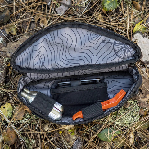 Open Outpost Corner Bike Bag with Built In Pockets For Gear No Seatpost Rattle Slim Frame Organizer for tools, showing contents.