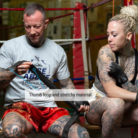 Premium Gym Grade Four Way Stretch Boxing Hand Wraps In Black displayed being applied, showcasing thumb loop and stretchy material.