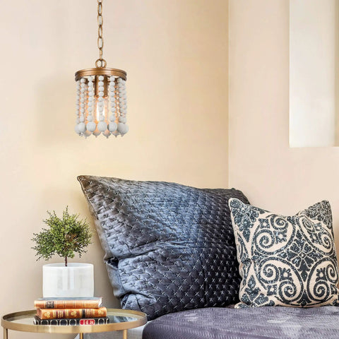 Beaded Chandelier Farmhouse Pendant Light With Antique Gold Finish And White Wood Beads in cozy bedroom setting