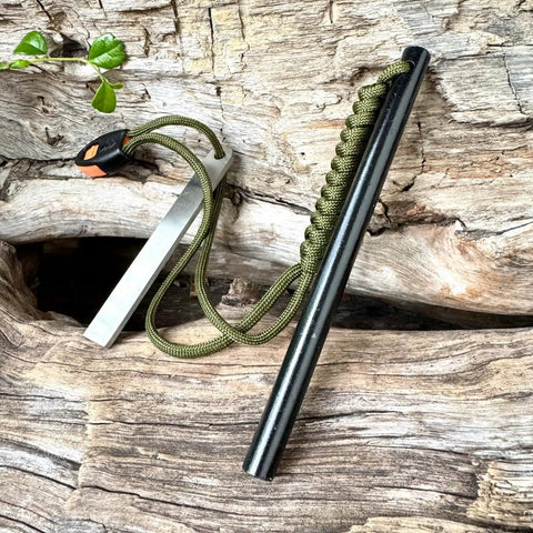 6 Inch Survival Fire Starter Ferro Rod With 3/8 Inch By 6 Inch Size on wooden surface, green paracord attached.