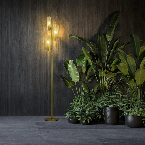 LED Tree Floor Lamp With 3 Light Heads In Brass Finish next to green plants, metal cage shade, industrial style in modern setting