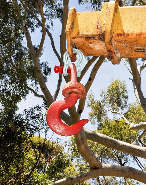 Hella Rugged Three Eighths Inch Galvanized Screw Pin Anchor Shackles Ten Pack Zinc Coated D Ring Connectors on a crane hook.