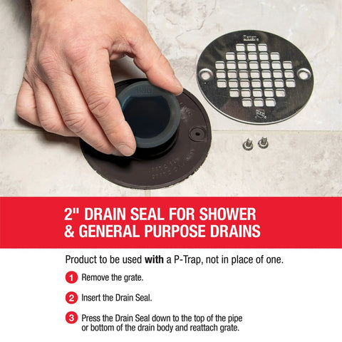Hand installing Seal For 2 Inch Shower And Floor Drain 43745 Black No Size Replacement Gasket into a floor drain, showing easy fit.