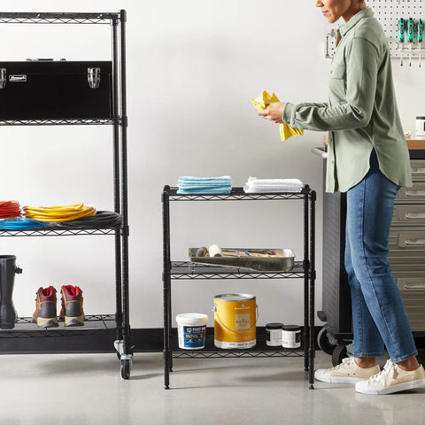 Heavy Duty Steel Wire Rack Shelf 3 Tier Adjustable Storage Organizer For Garage Kitchen, person organizing with towels, black metal design.