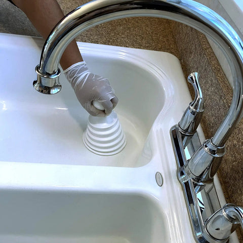 Mighty Tiny Plunger for Tight Bathroom and Kitchen Sinks, RV Ready, shown unclogging white sink with maximum push pull action