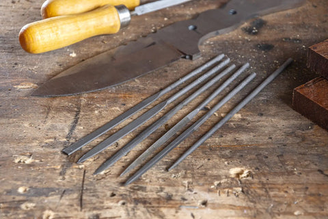 6 Piece Miniature File Set With Assorted Shapes For Detail Work displayed on a wooden table, Swiss Pattern Precision Files visible.