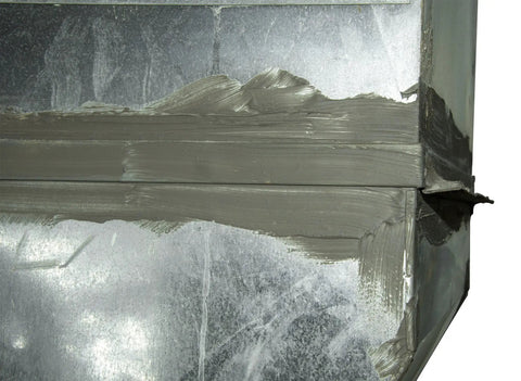 DS 110N One Pound Duct Seal Compound applied on metal surface, sealing gaps to block drafts, dust, moisture, and noise.