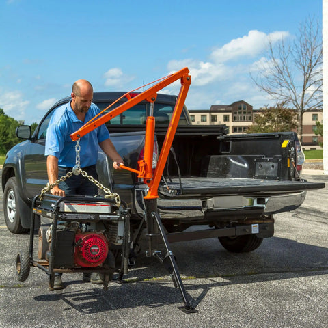 Man using Straight Up Heavy Duty Hitch Mounted Jib Crane For Pickup Trucks to lift generator from truck bed.