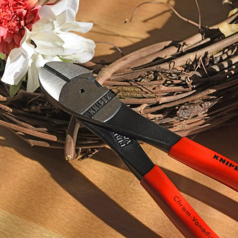 High Leverage Angled Diagonal Cutters 8 Inch with red handles, on wooden surface with floral background