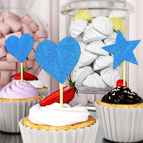 Cupcakes with royal blue glitter heart and star toppers on a dessert table.