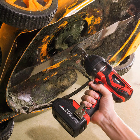 Using Beefy 20V Cordless Impact Wrench Kit With 300 Ft Lb Torque on an orange lawn mower blade underside.