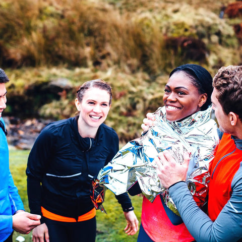 Group enjoying outdoors with Space Grade Emergency Survival Blanket Reflects Over 80 Percent Body Heat Windproof