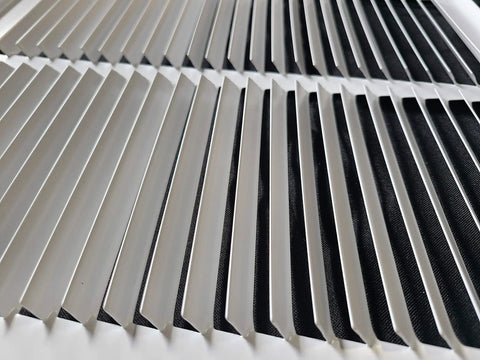 Close-up of sturdy steel return air grille for 24x6 duct opening, white vent cover for HVAC, showcasing slats detail.