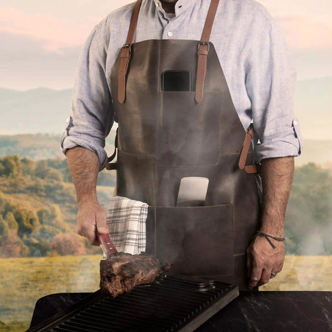 Man grilling in Genuine Leather Work Apron With CrossBack Straps For Woodworking Carpentry BBQ And Barista Tasks 3 Spacious Pockets