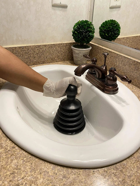 Gloved hand using Mighty Tiny Plunger For Tight Spaces And Small Drains, Perfect For Bathroom And Kitchen Sinks, RVs And More.