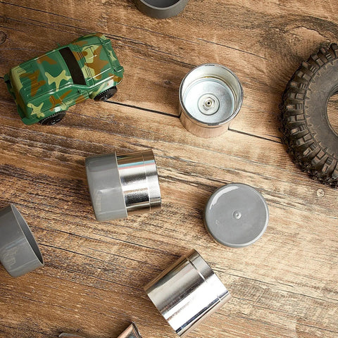 Heavy Duty Four Piece Trailer Wheel Bearing Protectors With Chromed Metal Dust Caps shown on wood surface beside toy car.