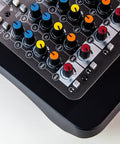 Close-up of Six Channel Compact Live Mixer with color-coded knobs and durable metal chassis, GS Pre preamps visible.