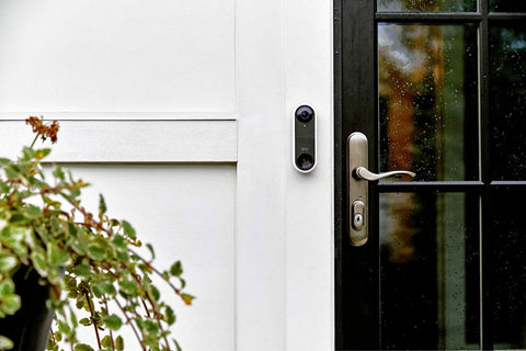 Essential Wired Video Doorbell With HD Video, 180 Degree View, Night Vision, Two Way Audio next to a front door