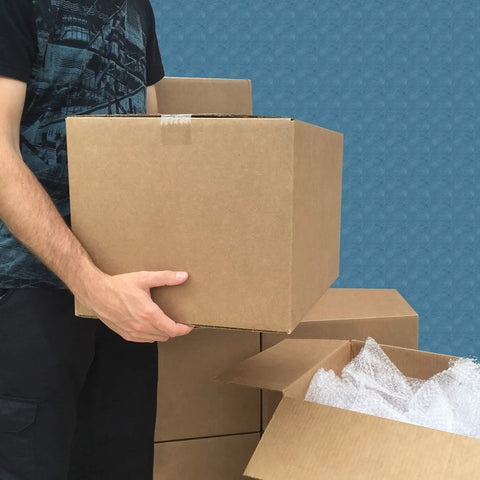 Person carrying Heavy Duty Corrugated Moving Boxes For No Drama Packing Medium 18X14X12 Inches Brown Cardboard Cartons.