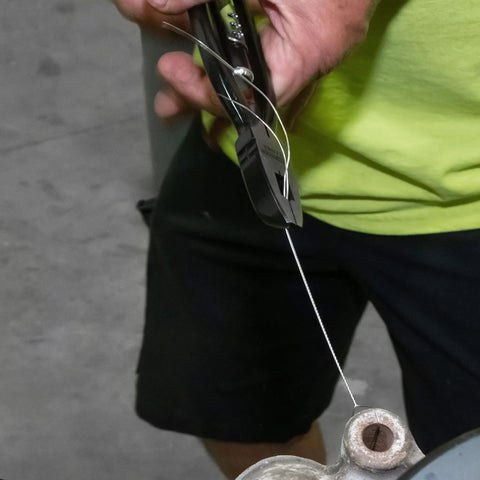 Heavy Duty Safety Wire Pliers With Reversible Twist Action for Cars Machinery and Aircraft, shown gripping and twisting wire.