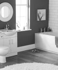 Modern bathroom interior with white fixtures, sink, bathtub, and polished wooden flooring