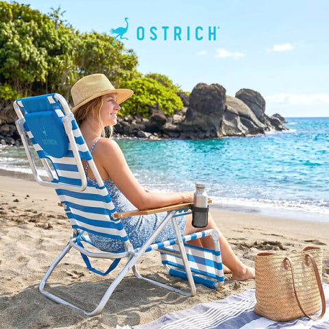Woman relaxing on a 3N1 Lightweight Beach Reclining Lounge Chair With Footrest, blue stripe, at a sunny beach.
