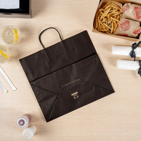 100 Pack Stand Open Paper Shopping Bags With Handles For Grab And Go Takeout And Retail Durable Kraft Paper Carrier Bags 14.17 X 8.26 X 13.19 Inches Easy Carry Totes shown on table with food items nearby