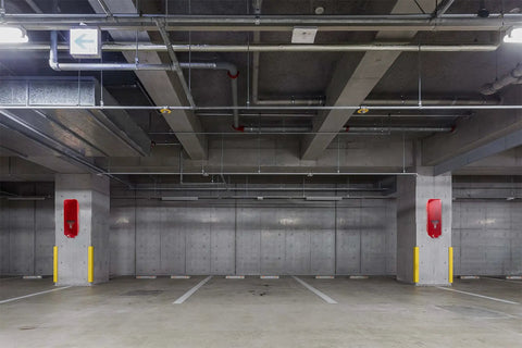 Built Tough Red Surface Mount Fire Extinguisher Cabinet With Lock Down Door And Quick Grip Pull Cover for outdoor safety in parking garage.