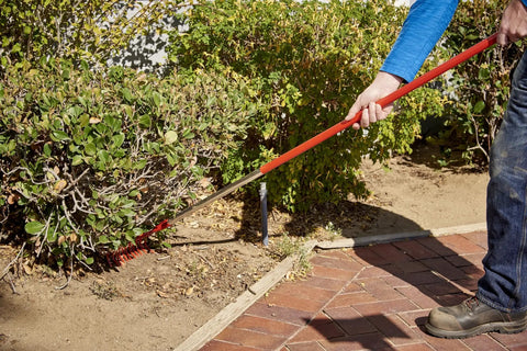 Person using Fixed Tine Shrub Rake With Aluminum Handle 8 Inch Wide For Quick Cleanup Of Leaves And Debris In Your Yard With Even Pressure