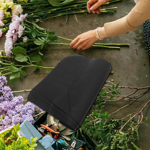 10 Piece Floral Embossed Kraft Paper Sheets with polka dot texture for bouquet wrapping, surrounded by flowers and tools.
