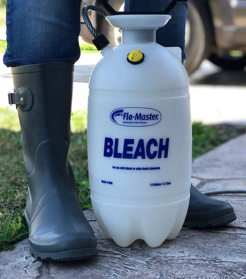 Person standing next to a 1.5 Gallon Bleach Sprayer Handheld Chemical Sprayer With Viton Seals on a concrete path.
