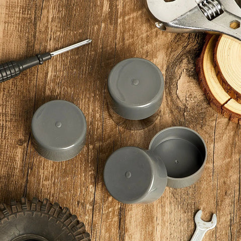 4 Pack Road Ready Rubber Trailer Bearing Dust Caps And Bearing Bras, 1.98 Inch Wheel Hub Covers For Boat Trailers, classic gray rubber caps on a wooden surface.