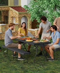 Six Foot Folding Picnic Table Set with Two Benches HDPE Wood Pattern Top used for outdoor dining in a garden setting