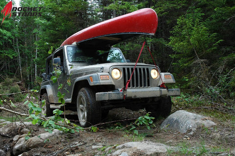 Jeep carrying red canoe secured with Beefy 4 Pack Ratchet Tie Down Straps With 1 Inch By 17 Feet Length, 2,200 Pound Break Strength.