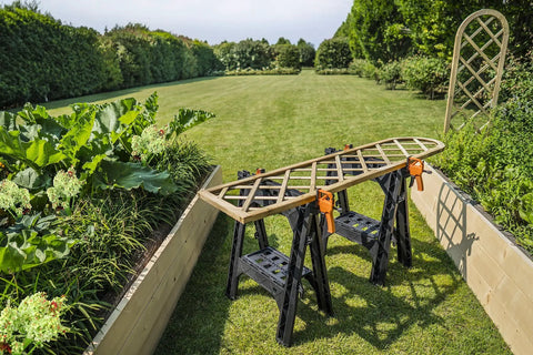 Integrated Bar Clamp Sawhorses for secure work on lawn with trellis secured, lightweight and portable at 4 lbs each