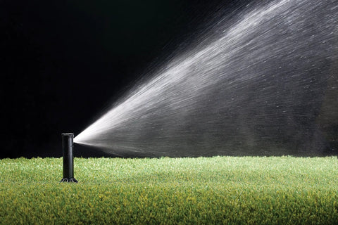 Simple Adjust Gear Drive Rotor 32SA spraying water on lawn; adjustable 40 to 360 degree pattern, 19 to 32 feet spray distance